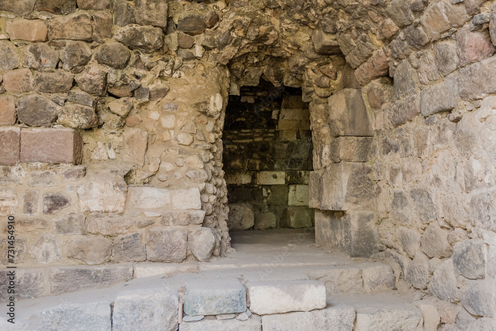 An entrance at an archaeological site showing weathered stones and textures in Izmir, Turkiye.