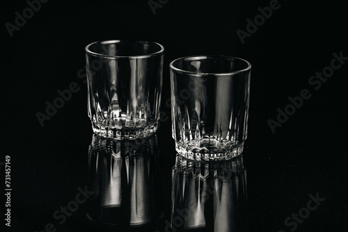 Black and white isolated empty Whiskey drinking crystal clear glasses with reflections