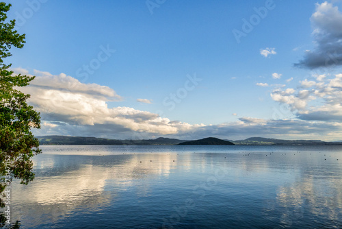 Summer Evening on Lake Rotorua, New Zealand - Looking south towards Mokoia Island from the north shore of the Lake. photo