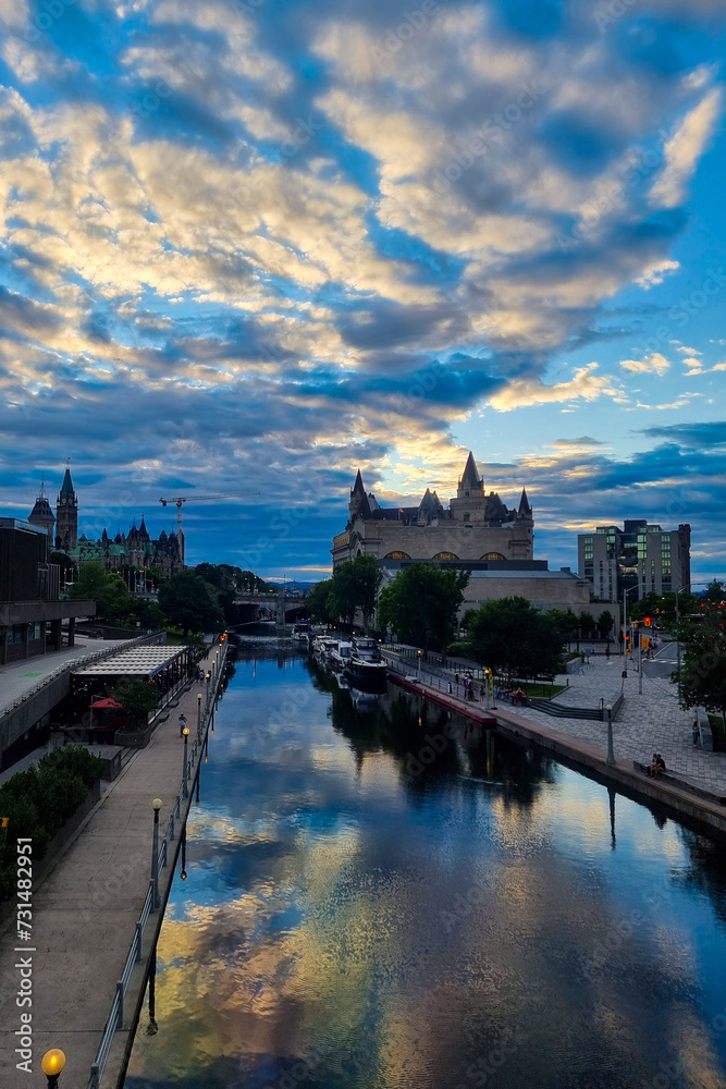 Obraz premium View of Canada parliament building in Ottawa during sunset. This photo is taken from MacKenzie King bridge above Rideau canal.