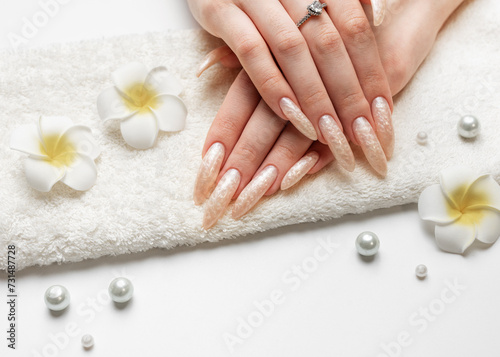 Hand of a young woman with white pearl  manicure