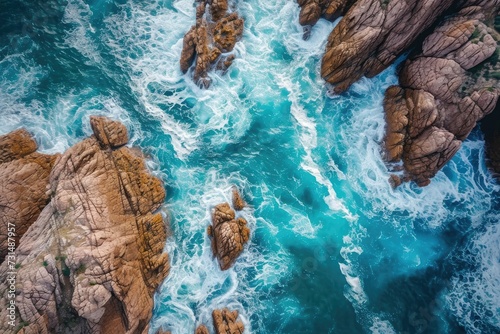 Breath-taking Aerial View of Ocean and Rocks, Natures Majestic Beauty for Your Eyes to Behold, A bird's eye view of turquoise sea waves crashing against enormous rocks, AI Generated