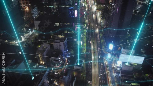 High angle view of busy multilane thoroughfare in modern metropolis. Aerial evening shot of traffic in streets of city. Jakarta, Indonesia. Added augmented reality visual effects photo
