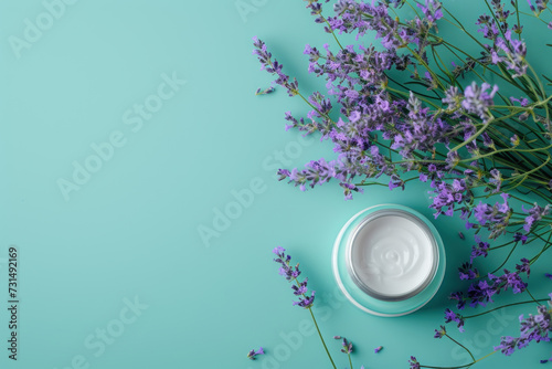 Top view flat lay cosmetics box with flower lavender plant on turquoise blue background