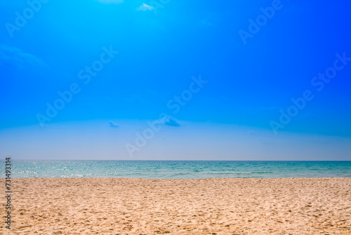 Beach sand for summer vacation concept. Beach nature and summer seawater with sunlight light sandy beach Sparkling sea water contrast with the blue sky.Beach sand for summer vacation concept. 