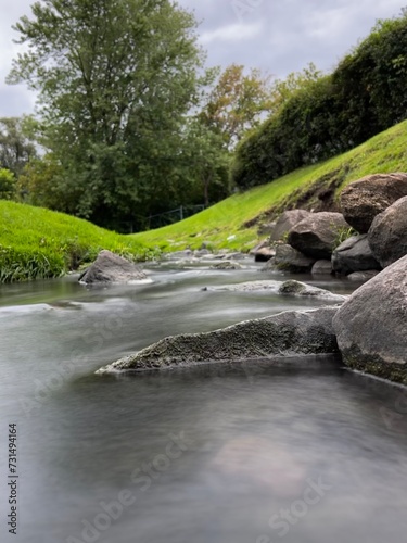 Close-up of River Water Flowing over Rocks. Long Exposure