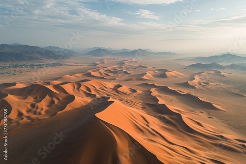 An overhead perspective capturing the expansive sand dunes stretching across the desert landscape  Aerial overview of vast  undulating sand dunes in a desert  AI Generated