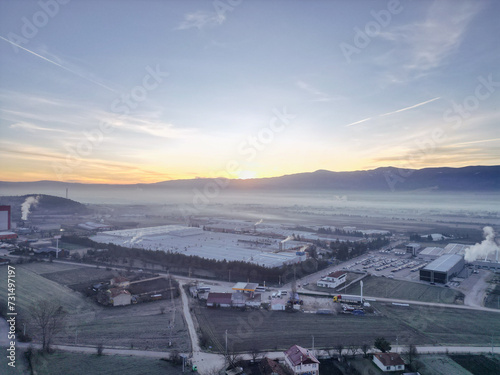 The sun rises in a foggy village aerial view