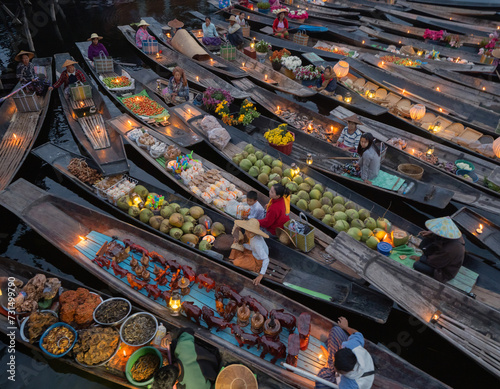 Damnoen Saduak Floating Market or Amphawa. Local people sell fruits, traditional food on boats in canal, Ratchaburi District, Thailand. Famous Asian tourist attraction destination. Festival in Asia.