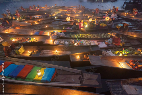Damnoen Saduak Floating Market or Amphawa. Local people sell fruits, traditional food on boats in canal, Ratchaburi District, Thailand. Famous Asian tourist attraction destination. Festival in Asia.