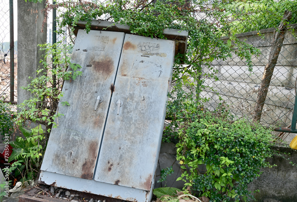 BANGKOK, THAILAND - February 15, 2024: Old rusty iron cabinet abandoned on the side of the road with natural background at Thailand. BANGKOK, THAILAND - February 15, 2024: Old rusty iron cabinet abandoned on the side of the road with natural background at Thailand.