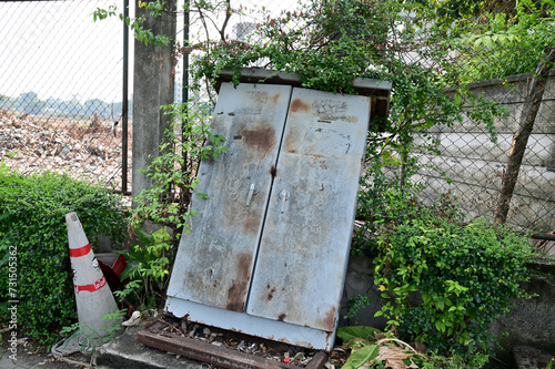 BANGKOK, THAILAND - February 15, 2024: Old rusty iron cabinet abandoned on the side of the road with natural background at Thailand.