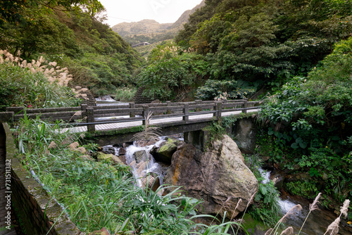 Little bridge build on the big rocks across that little stream in Jinguashi, New Taipei City, Taiwan.