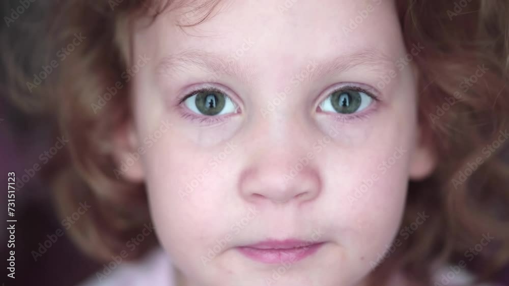 fair-haired curly girl looking into the camera fair-haired curly girl looking into the camera