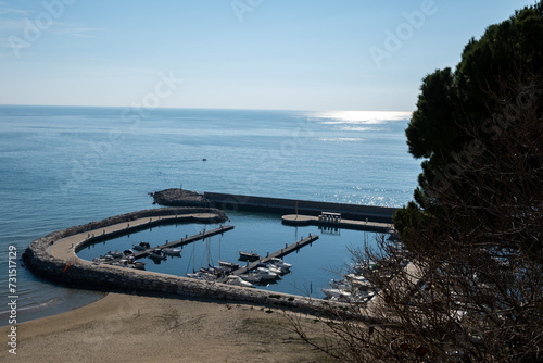 View on empty yachts harbour from hilly medieval small touristic coastal town Sperlonga and sea shore, Latina, Italy