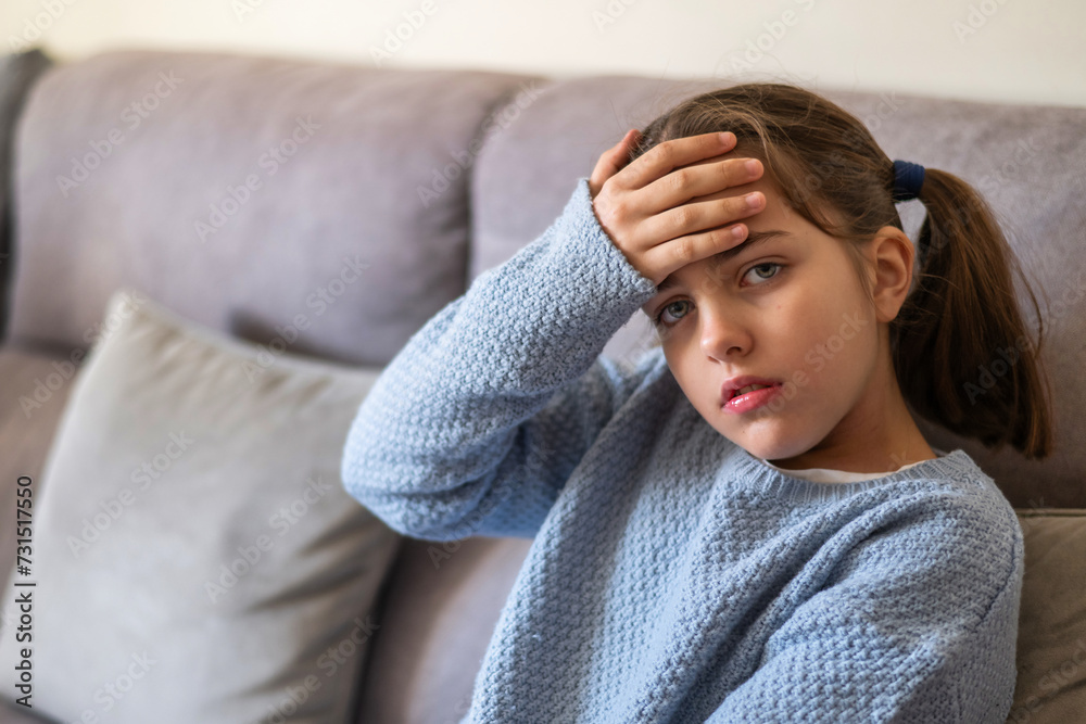 Little Girl With Her Hand On Her Forehead, Concept Of Flu, Fever, Cold Or Virus Symptoms In Young Children. Little Girl With Her Hand On Her Forehead, Concept Of Flu, Fever, Cold Or Virus Symptoms In Young Children.