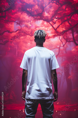 Person standing back in white long mockup t-shirt, fancy pink surroundings, park at night photo