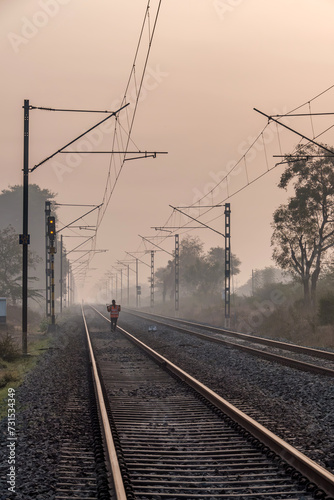 An Indian railway gangman at work near Pune India. Gangmen inspect and maintain railway tracks for the Indian Railways. photo