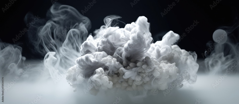 White cloud of smoke on a black background.