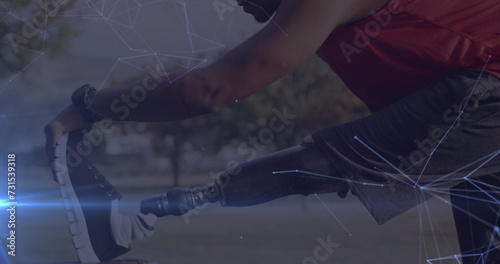 Image of glowing communication network over male athlete with prosthetic leg exercising outdoors