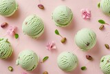 Each scoop of ice cream is light green with visible bits of red and brown, indicating the presence of mixed ingredients like cherries or nuts