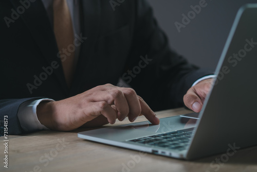 professional business man hand online working, focused ethnic male student working on laptop, remote studying using computer laptop looking at screen watching seminar webinar at home office.