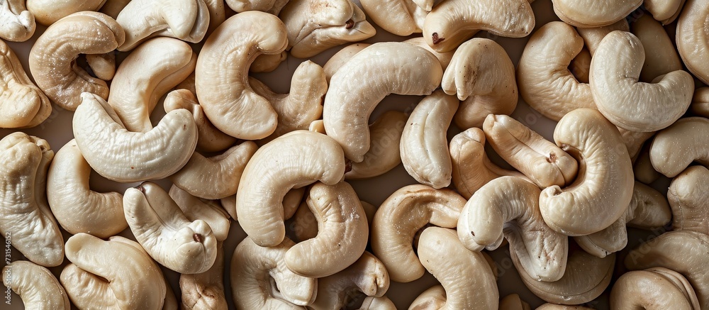 A stack of cashews, a popular ingredient in cuisine and natural foods, resting on a table. A stack of cashews, a popular ingredient in cuisine and natural foods, resting on a table.