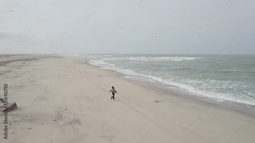 Girl running along the Atlantic Ocean, Africa Coast Girl running along the Atlantic Ocean, Africa Coast