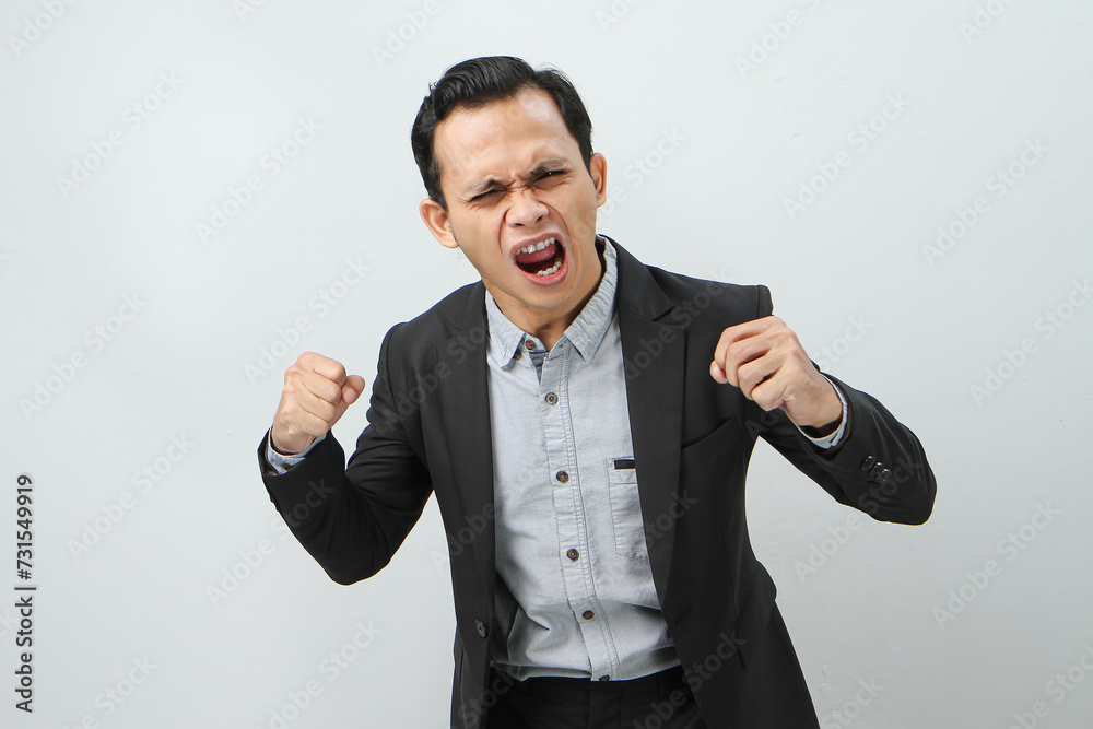 Andry mad asian indonesian business man in suit on isolated background Andry mad asian indonesian business man in suit on isolated background