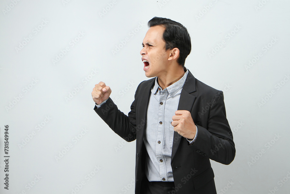 Andry mad asian indonesian business man in suit on isolated background Andry mad asian indonesian business man in suit on isolated background