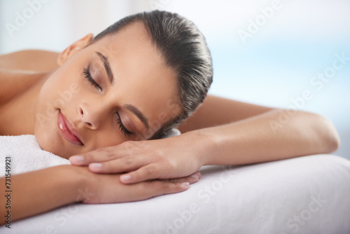 Relax  sleeping and woman at spa with wellness  self care and luxury skin treatment for zen. Calm  cosmetics and young female person with beauty body routine taking nap on towel at health salon.