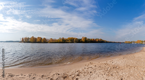 Photos Wide navigable river with sandy shore against forested opposite bank