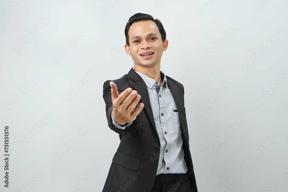 Happy confident asian indonesian business man in suit with presenting hand gesture on isolated background Happy confident asian indonesian business man in suit with presenting hand gesture on isolated background