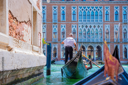 gondolier in grand canal, italy