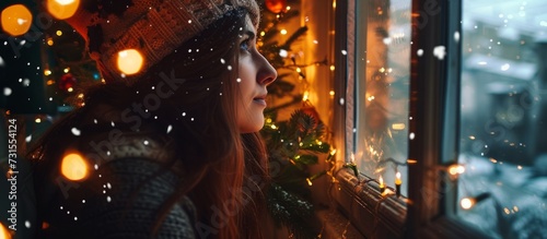 A woman enjoys the festive event of looking out of a window, where a dazzling Christmas tree brings warmth and entertainment, amid the darkness of the city. The scene showcases the art of celebration.
