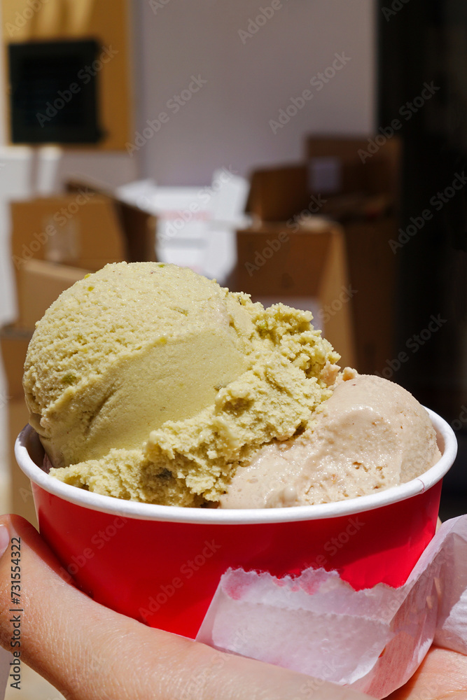 Close up Hand holding red paper take away cup of ice cream gelato Close up Hand holding red paper take away cup of ice cream gelato