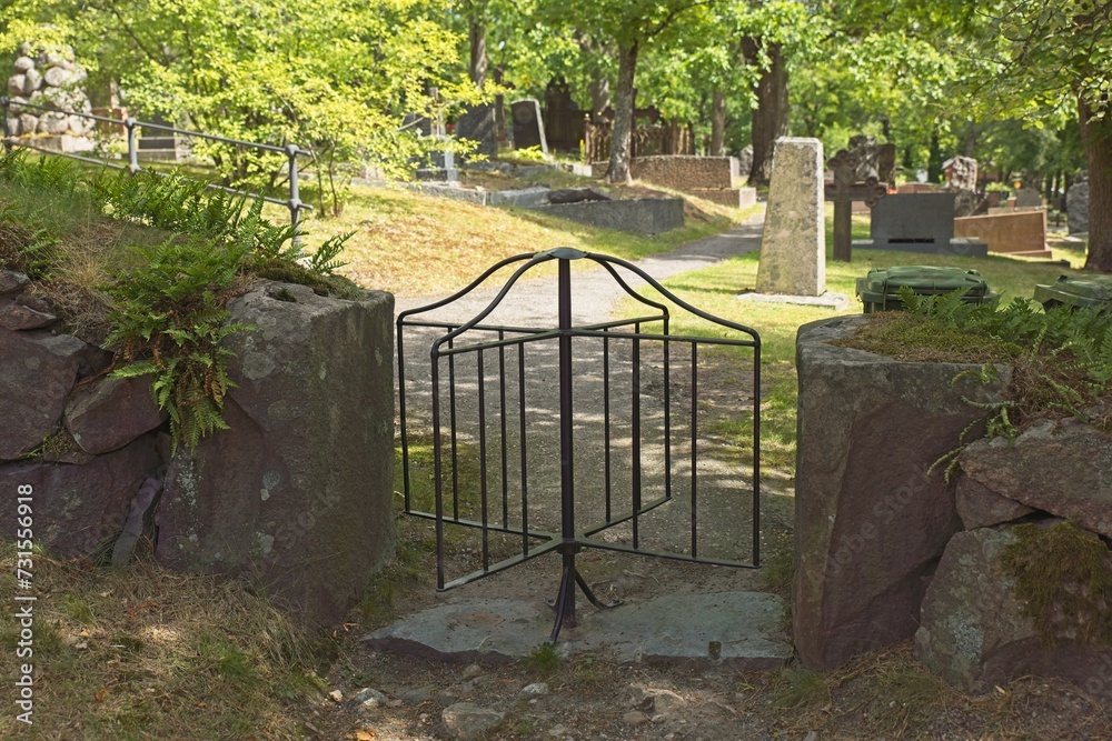 Revolving iron cemetery gate in summer, Tammisaari, Finland.