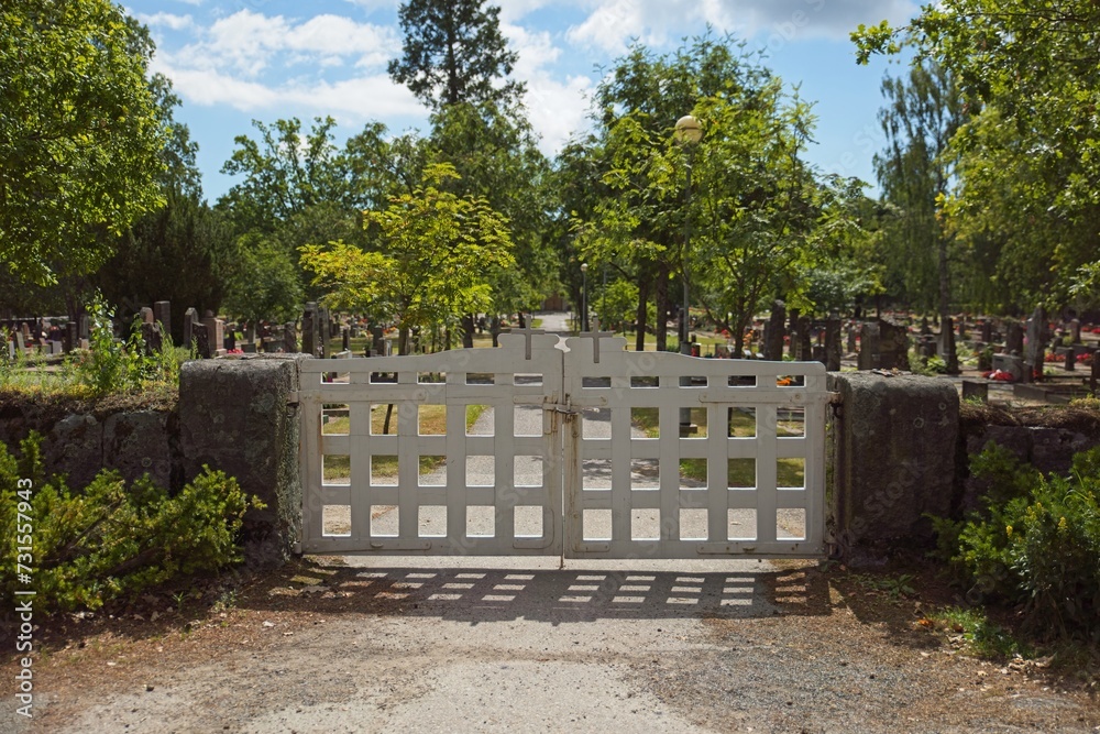 Old decorative wooden cemetery gate in summer, Tammisaari, Finland. Old decorative wooden cemetery gate in summer, Tammisaari, Finland.