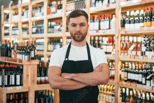 Wine shop owner in white shirt and black apron