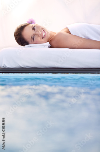 Massage, portrait and woman at spa poolside for health, wellness and luxury holistic treatment. Self care, peace and face of girl on pool bed for body therapy, comfort and calm hotel service to relax