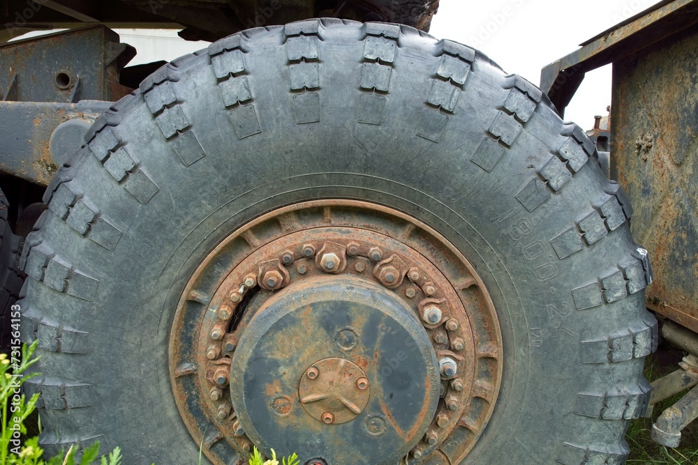 Closeup of old rusty wheel rim of haul truck.