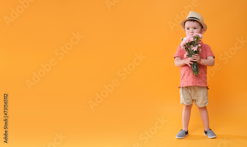 Little boy with a bouquet of flowers.
