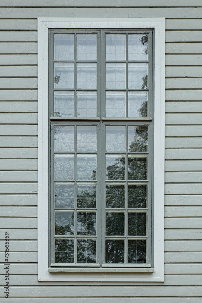 Fototapeta premium Window with many small frames with white frame on a green painted wood wall.