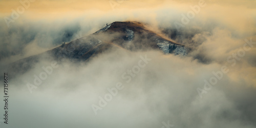 Lone peaks emerge from the morning fog in Eastern Washington's backlands on an early winter day