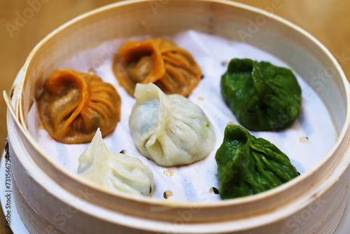 colorful steamed Jiaozi (dumpling) in steamer. Traditional Chinese food