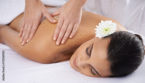 Woman, back massage and beauty treatment at spa, wellness and muscle therapy for body care. Female person, masseuse and health by dermatology, calm and resting at resort hotel and peace or zen