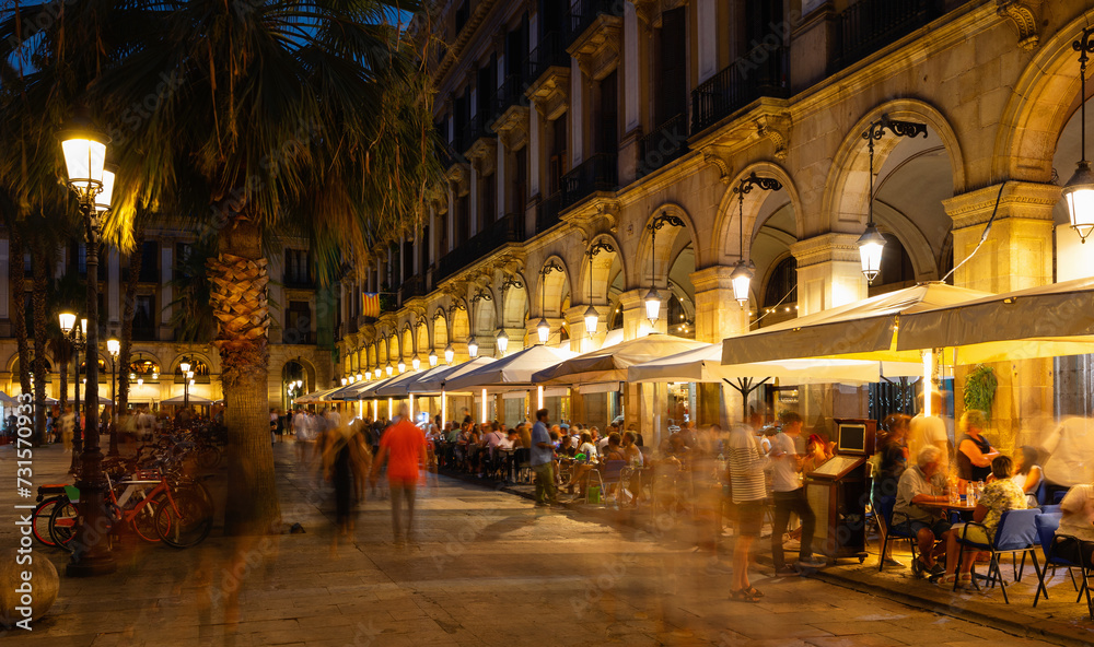 Visitors at bars and restaurants at Placa Reial - square in Barri Gotic of Spanish Barcelona