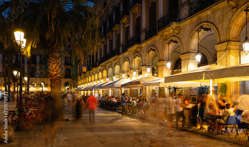Visitors at bars and restaurants at Placa Reial - square in Barri Gotic of Spanish Barcelona