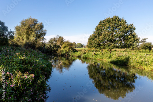 A view of the River Ouse at Barcombe Mills, with a blue sky overhead