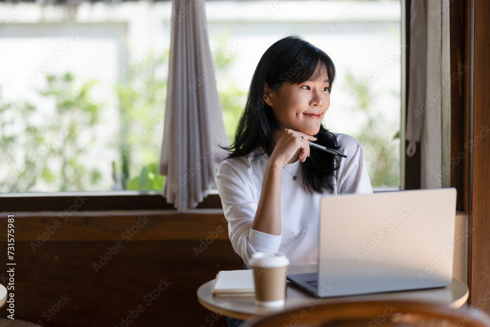 Pensive young adult woman working on a laptop in a cozy home setting, deep in thought.. Pensive young adult woman working on a laptop in a cozy home setting, deep in thought..